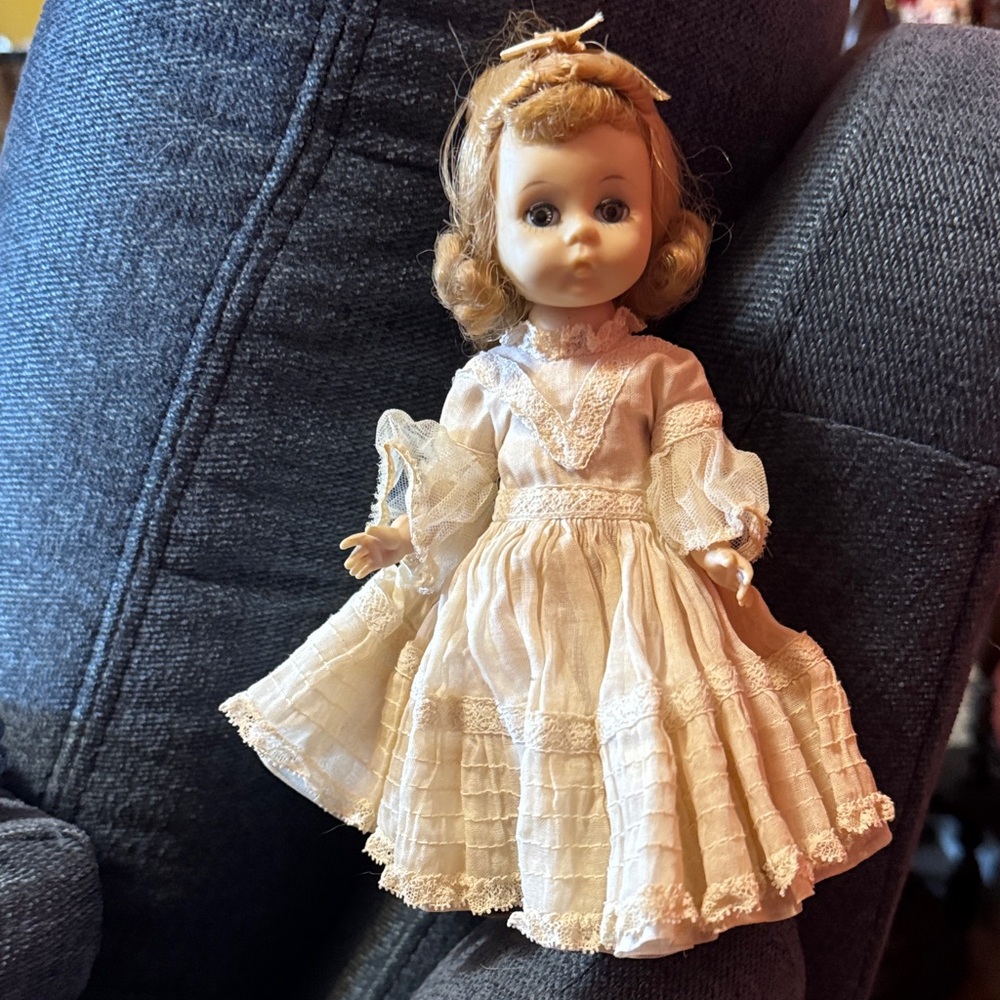 1970s circa Madame Alexander doll with cream lace dress and pink underclothes.